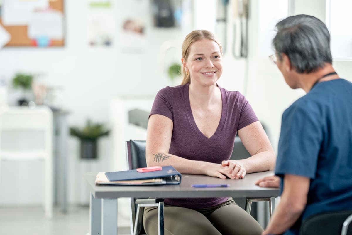 Ocularist meeting with a smiling patient during a consultation